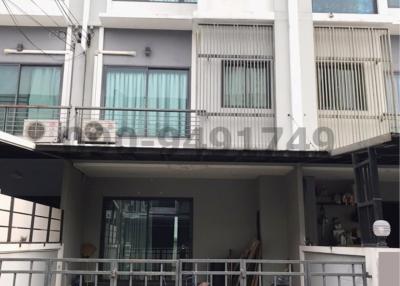 Modern townhouse exterior with garage and balcony