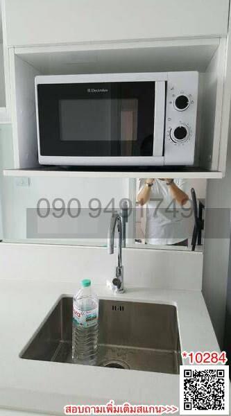 Modern compact kitchen with microwave and stainless steel sink