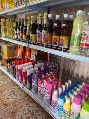 Shelves stocked with various household goods and groceries