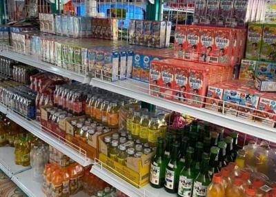 Shelves stocked with various beverages and food items in a store