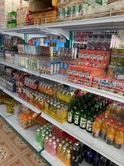 Shelves stocked with various beverages and food items in a store