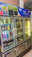 Commercial refrigeration units stocked with assorted beverages