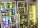 Commercial refrigeration units stocked with assorted beverages