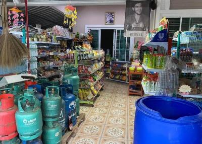 Interior of a small convenience store with various products and gas cylinders