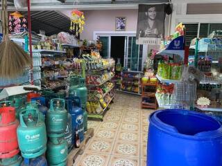 Interior of a small convenience store with various products and gas cylinders