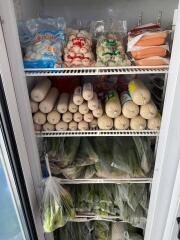 Fully stocked refrigerator interior with various food items