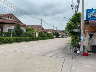 Suburban street view with residential houses and utility poles