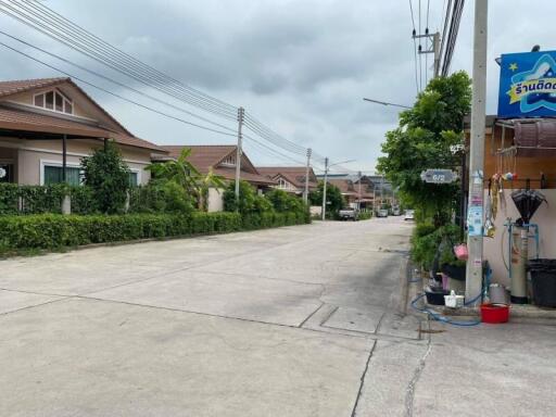 Suburban street view with residential houses and utility poles