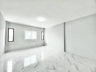Spacious and bright empty interior space with marble flooring and ample natural light
