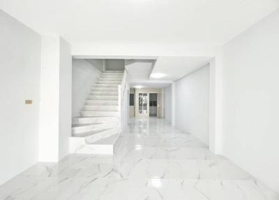 Bright spacious interior with marble floors and staircase