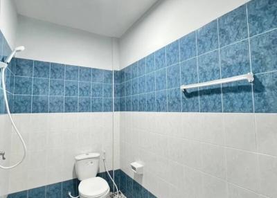 Modern bathroom with blue tiles and patterned floor