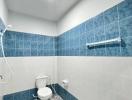 Modern bathroom with blue tiles and patterned floor
