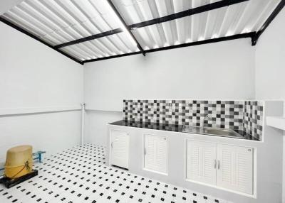 Modern kitchen with checkered floor and stainless steel sink