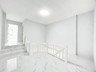 Bright and spacious upstairs hallway with marble flooring