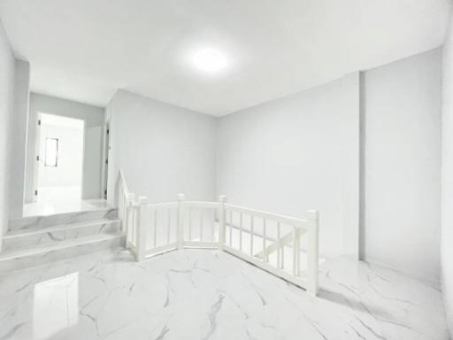 Bright and spacious upstairs hallway with marble flooring