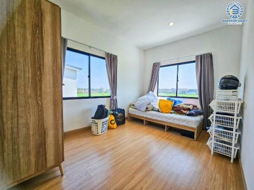 Cozy bedroom with natural lighting and wooden flooring