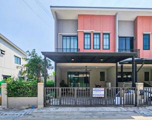 Modern Two-Story House with Balcony and Carport