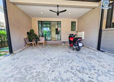 Spacious covered patio area with concrete flooring and ceiling fan