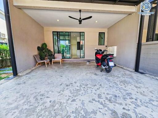 Spacious covered patio area with concrete flooring and ceiling fan