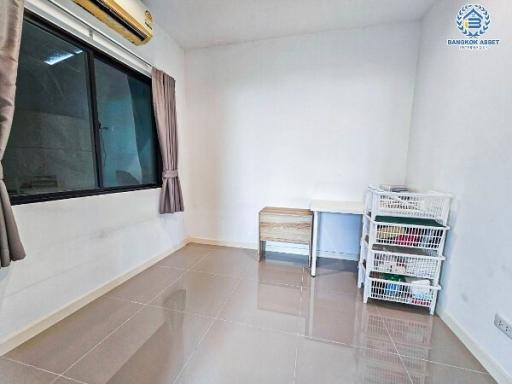 Minimalist bedroom with tiled flooring and air conditioning