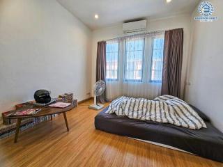 Cozy bedroom with large window and essential furniture