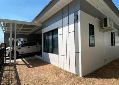 Modern house exterior with large windows and carport