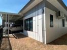 Modern house exterior with large windows and carport