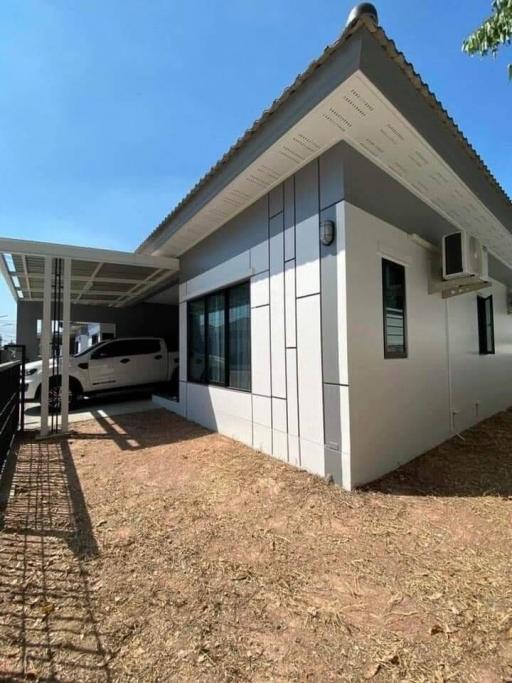 Modern house exterior with large windows and carport