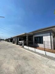 Suburban single-story homes with clear skies