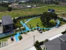 Aerial view of a residential property with landscaped garden and driveway