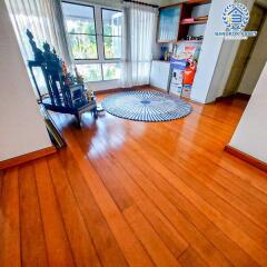 Spacious living room with wooden flooring and large windows