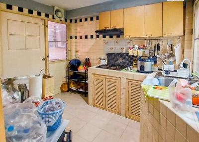 Compact kitchen with wooden cabinets and tiled backsplash
