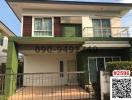 Modern two-story residential home with green awning