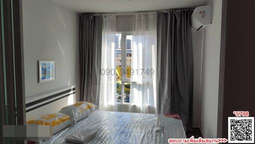 Cozy modern bedroom with natural light and balcony access