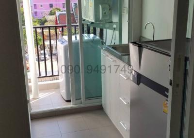 Compact kitchen with modern appliances and balcony access