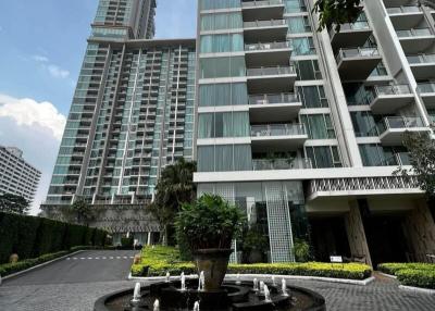 Exterior view of a modern apartment complex with a fountain