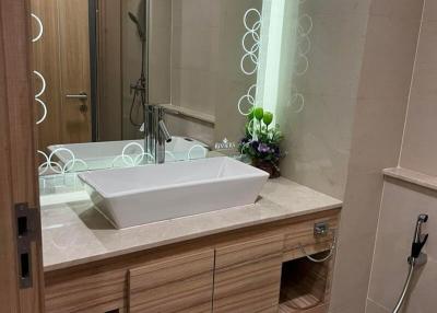 Modern bathroom with spacious vanity, large mirror, and glass shower