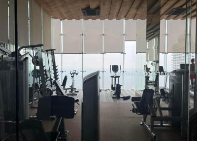 Modern gym with floor-to-ceiling windows and city view