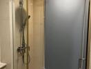 Modern frameless glass shower with stainless steel fixtures in a bathroom