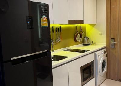 Modern kitchen with white cabinetry and stainless steel appliances