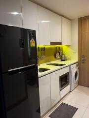 Modern kitchen with white cabinetry and stainless steel appliances