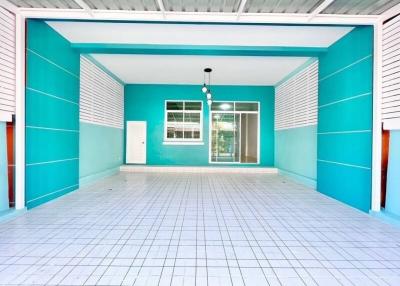 Spacious and bright empty room with blue walls and white floor tiles