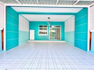 Spacious and bright empty room with blue walls and white floor tiles