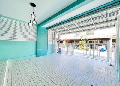 Covered patio area with tile flooring and metal security door