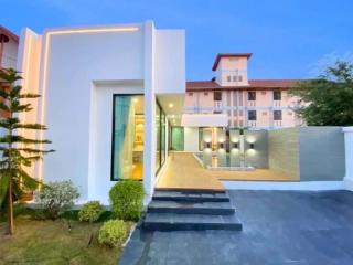 Modern white building exterior at dusk with lighting