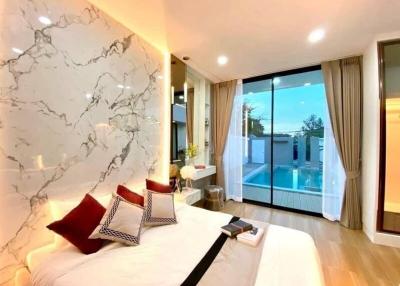 Modern bedroom with marble wall and pool view through large window