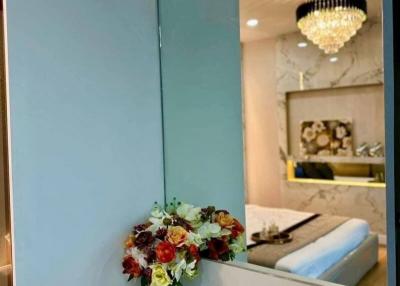 Elegant Bedroom with Chandelier and Floral Arrangement