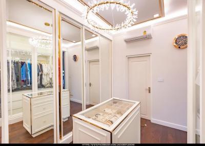 Elegant walk-in wardrobe with mirrored closets and stylish lighting