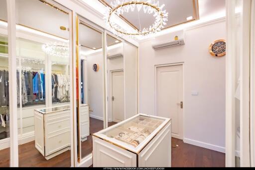 Elegant walk-in wardrobe with mirrored closets and stylish lighting