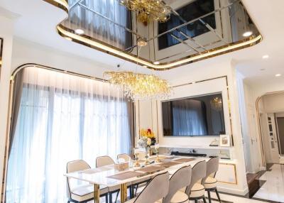 Elegant dining room with modern chandelier and reflective ceiling